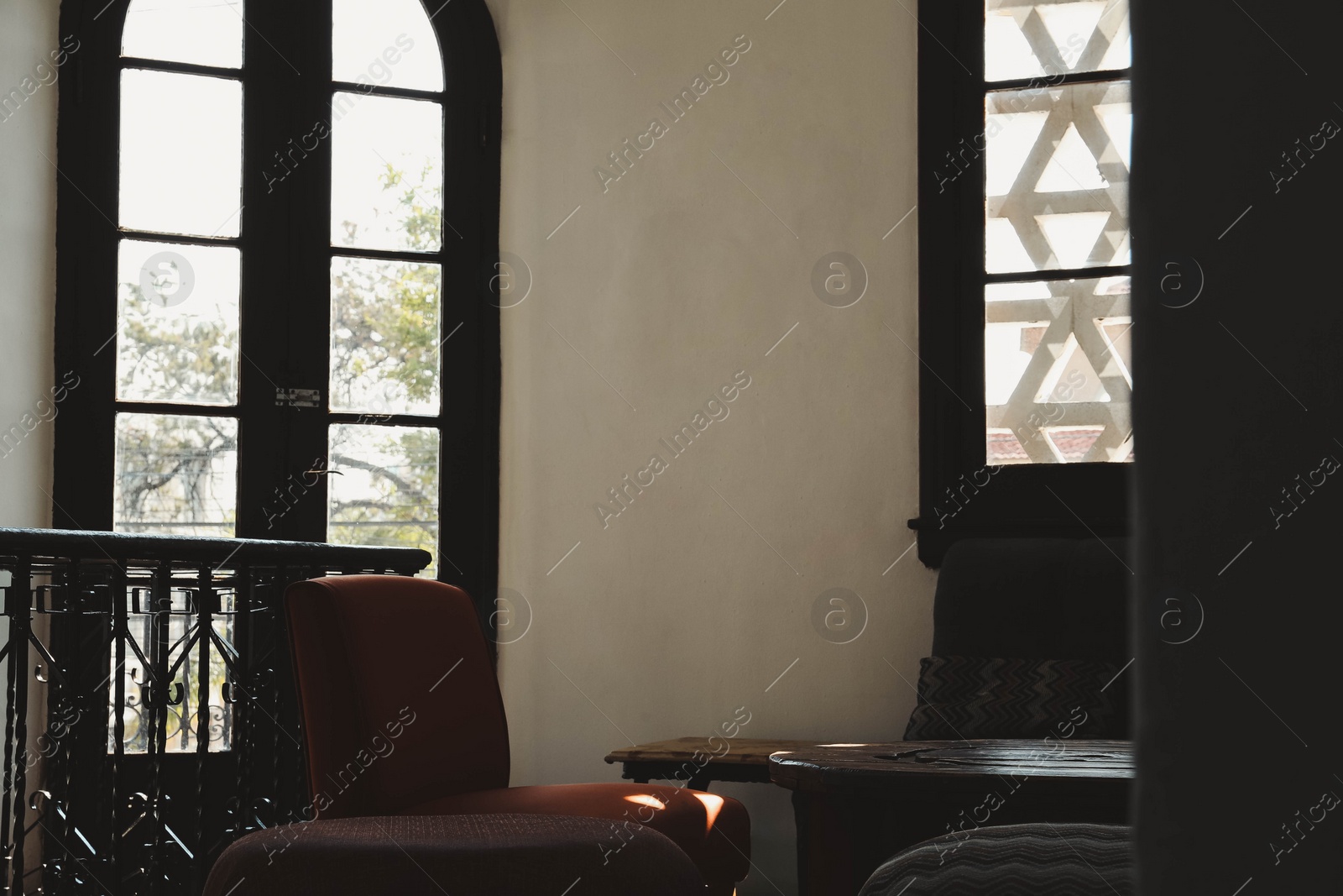 Photo of Cozy cafe interior with sofa, chairs and table