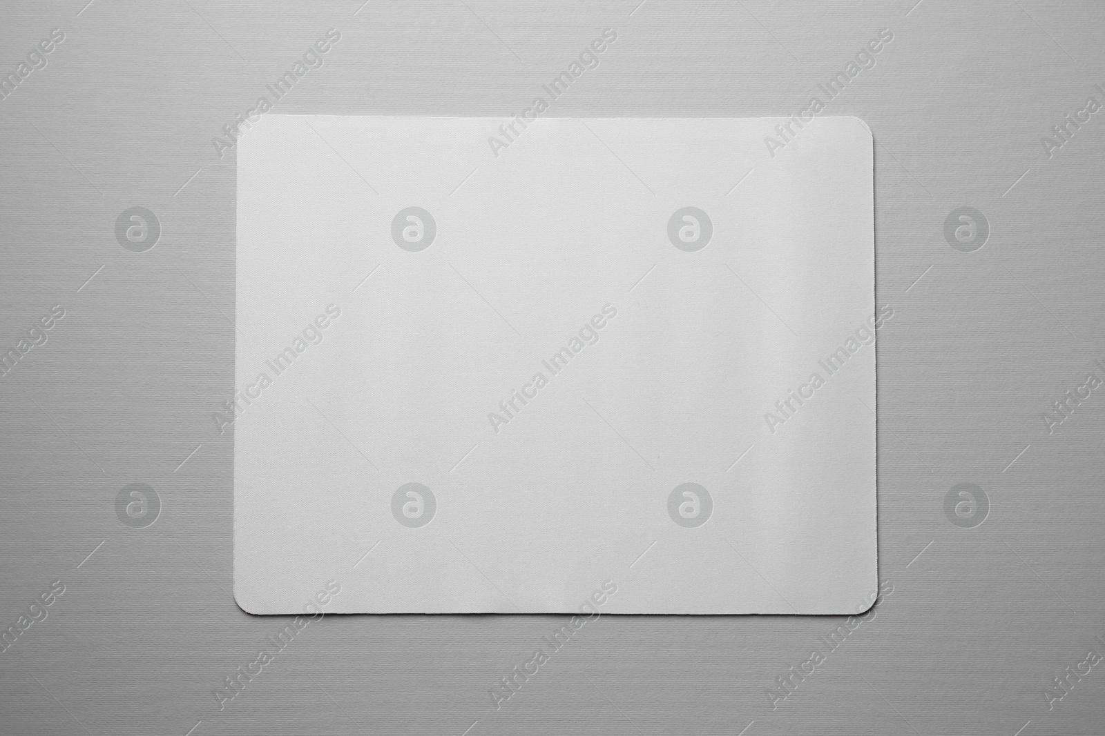 Photo of One mouse pad on grey background, top view. Space for text