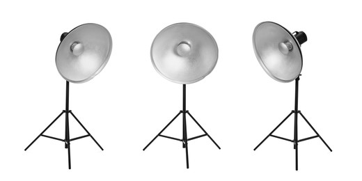 Image of Set with studio flash lights with reflectors on tripods against white background. Banner design
