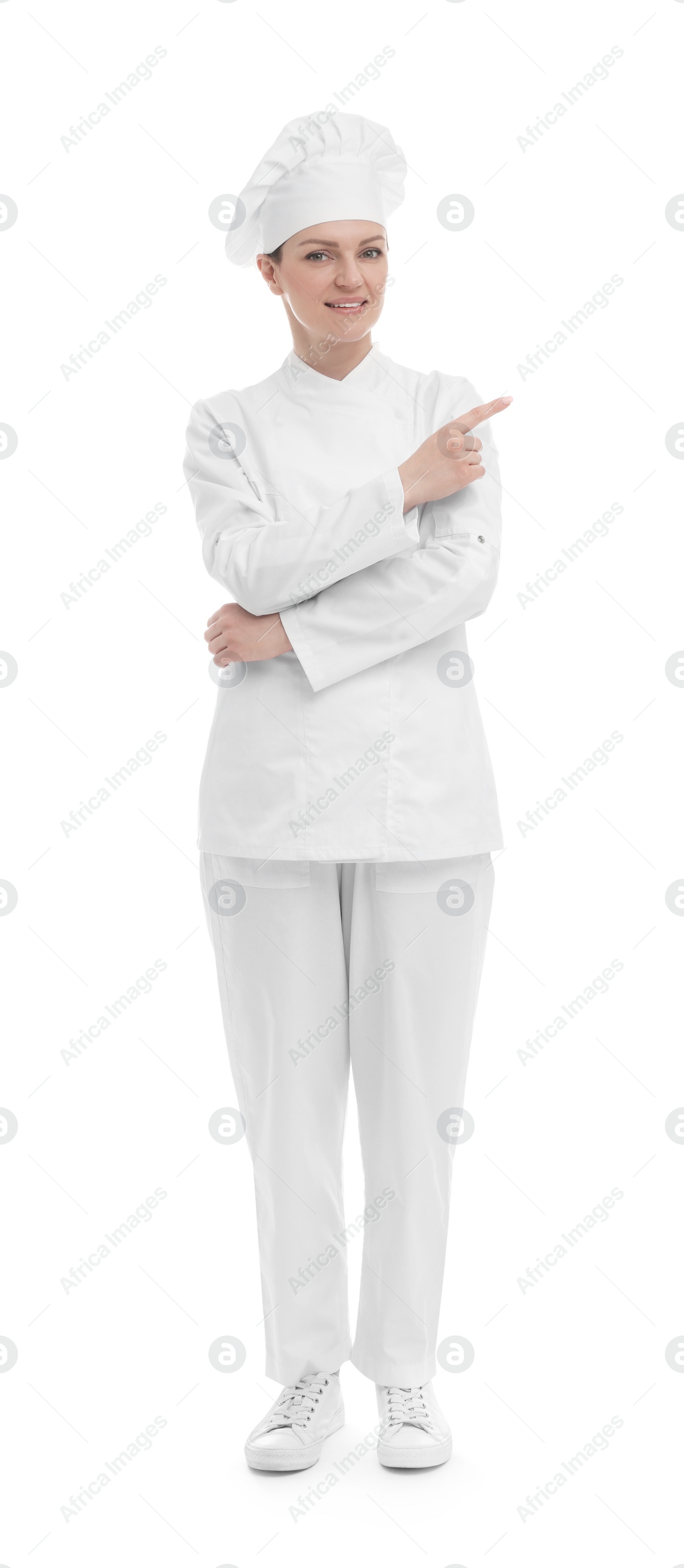 Photo of Happy woman chef in uniform pointing at something on white background