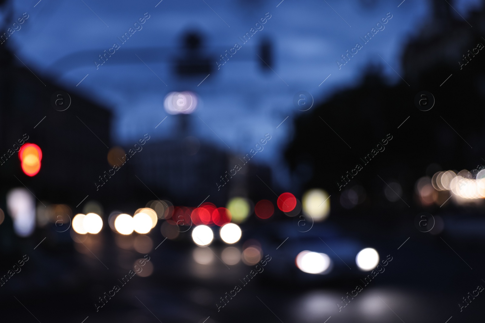 Photo of Blurred view of modern city at evening. Bokeh effect