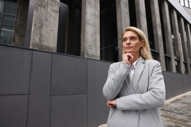 Photo of Portrait of thoughtful woman outdoors, space for text. Lawyer, businesswoman, accountant or manager