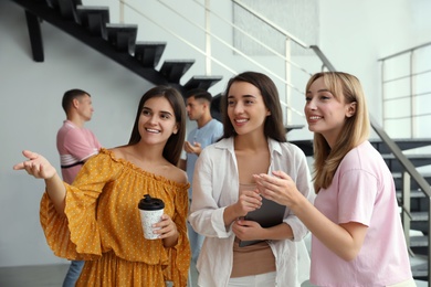 Group of women having conversation in hall