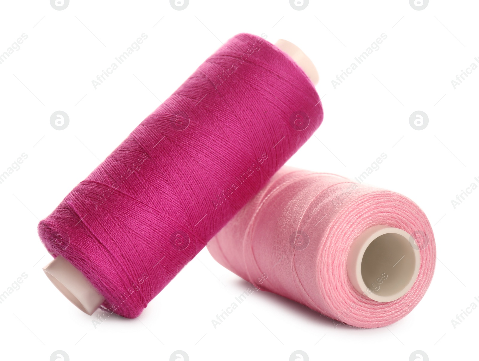 Photo of Different colorful sewing threads on white background, closeup