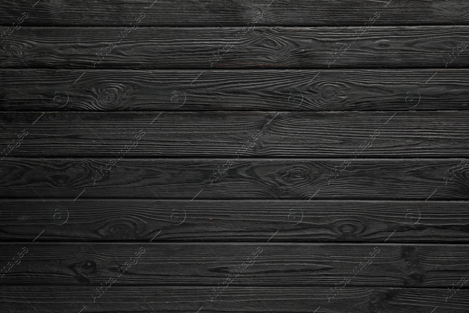 Photo of Texture of black wooden surface as background, top view