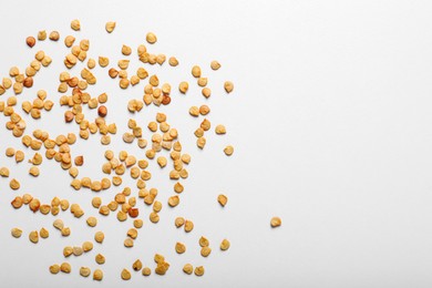 Photo of Many pepper seeds on white background, top view