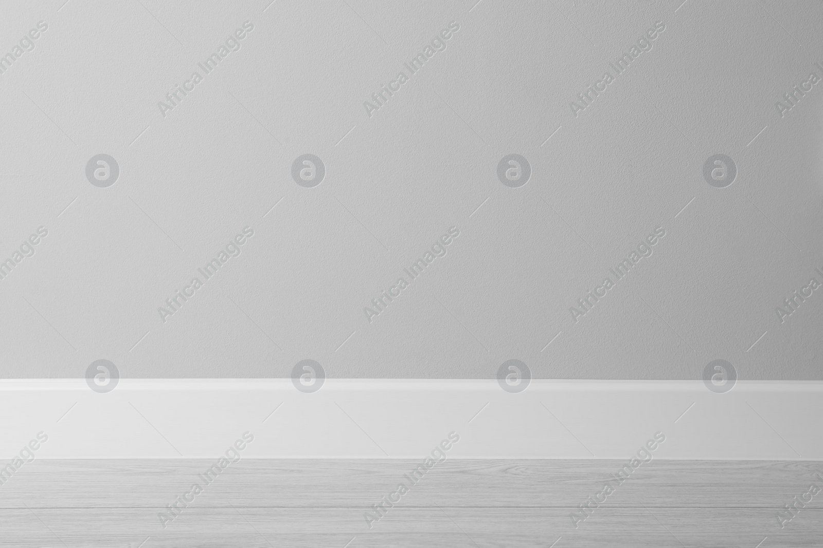 Photo of White plinth on laminated floor near wall indoors