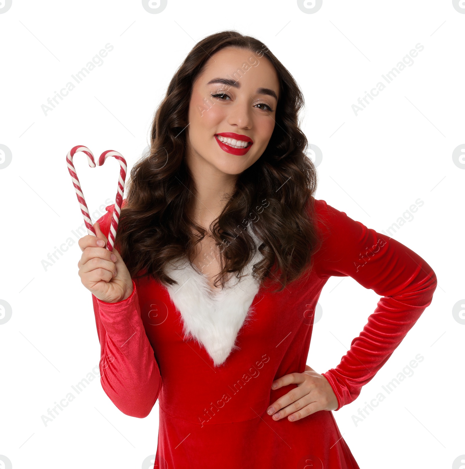 Photo of Beautiful young woman in Christmas red dress and candy canes isolated on white