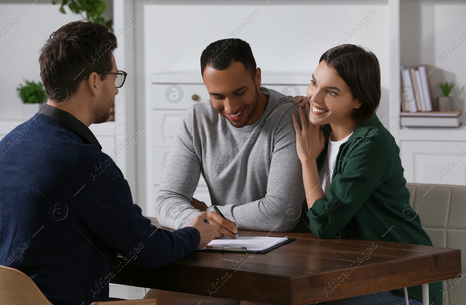 Photo of Professional notary working with couple in office