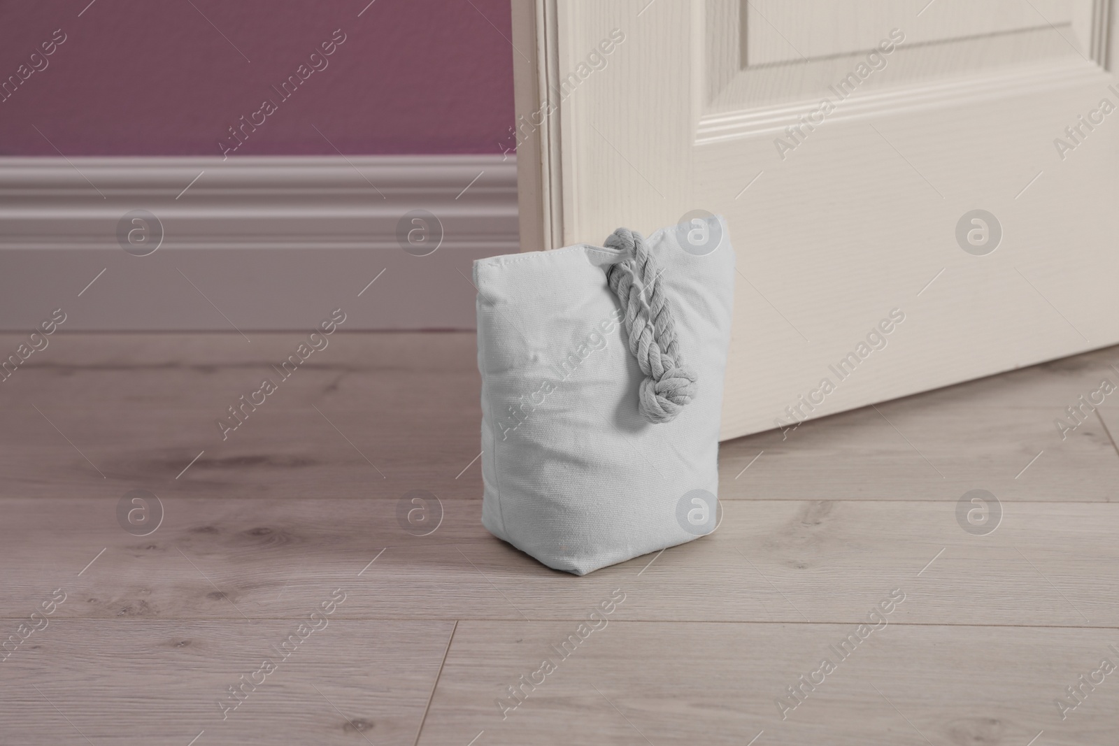 Stuffed bag holding wooden door at home Photo of Stuffed bag holding wooden door at home