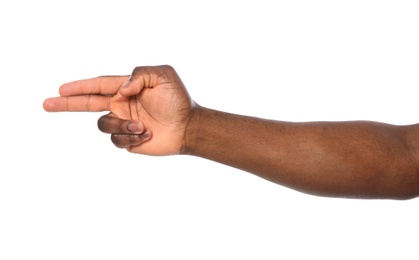 Photo of African-American man showing shoot gesture on white background, closeup