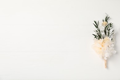 Beautiful boutonniere on white background, top view. Space for text