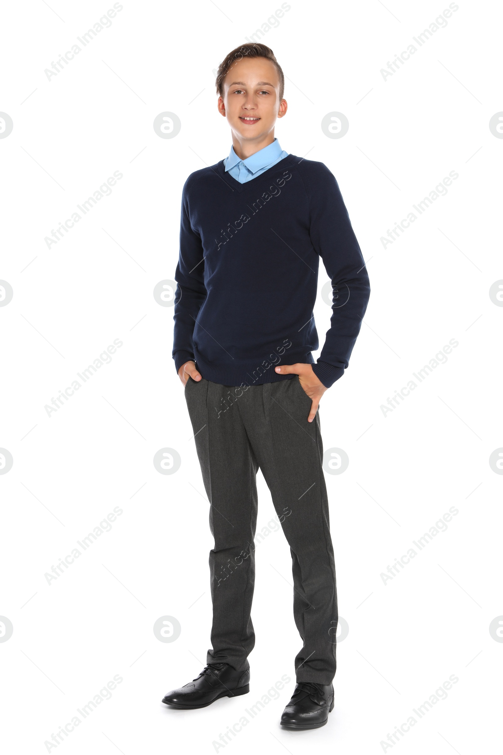 Photo of Teenage boy in stylish school uniform on white background