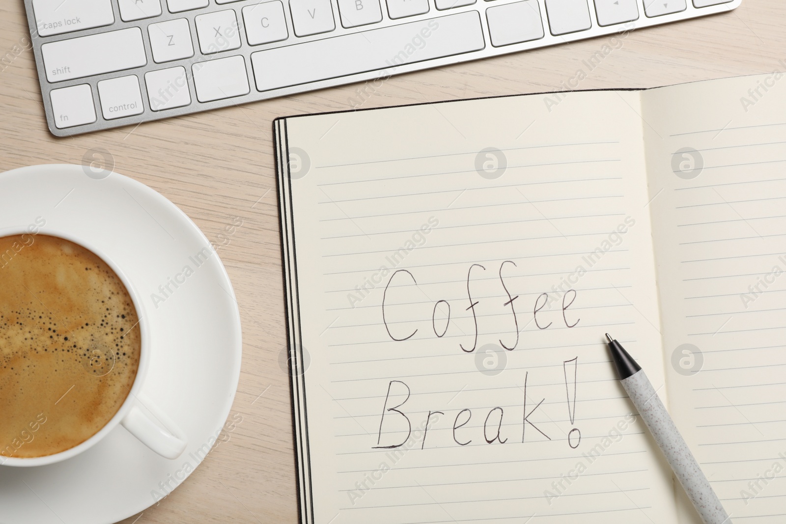 Photo of Notebook with phrase Coffee Break, cup of drink and keyboard on wooden table, flat lay