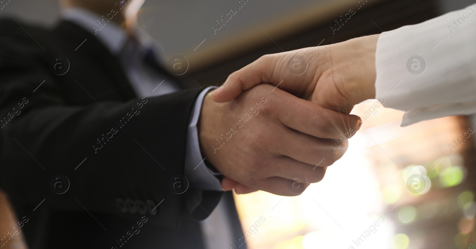 Image of Business partners shaking hands after meeting in office, closeup. Banner design