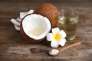 Photo of Composition with natural organic coconut oil on wooden table