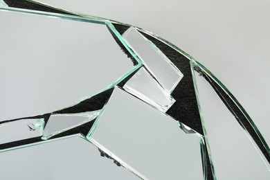 Shards of broken mirror on dark background, top view