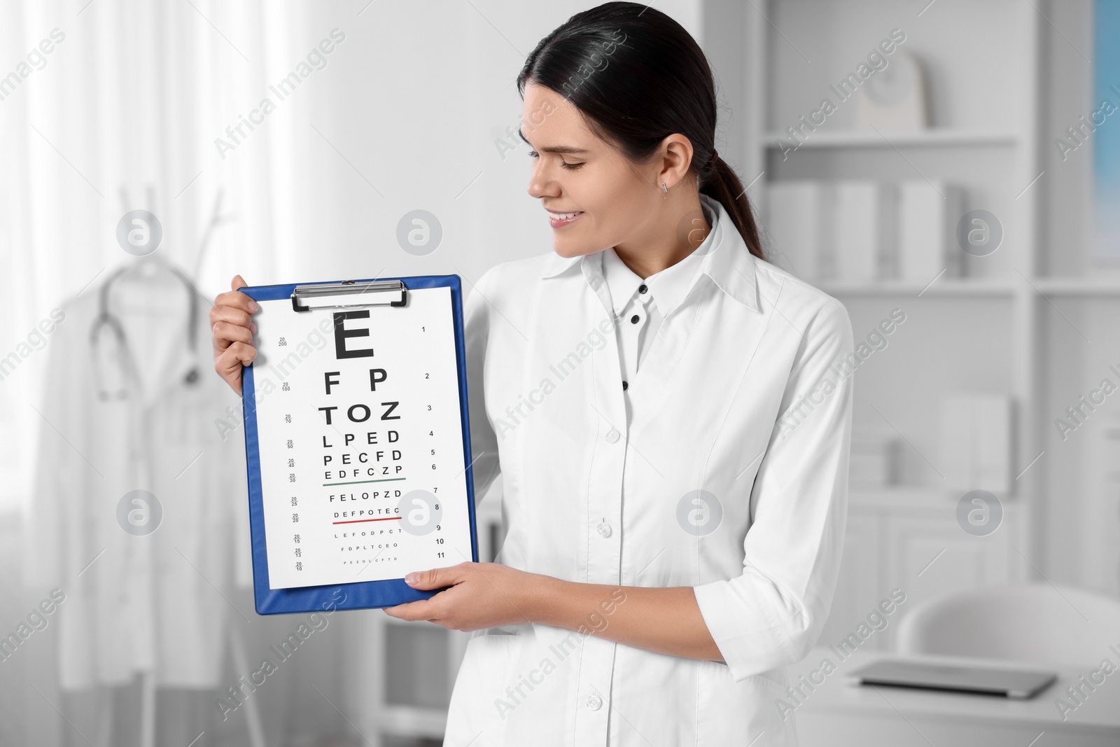 Photo of Ophthalmologist with vision test chart in clinic