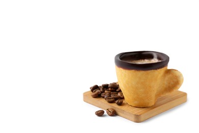 Delicious edible biscuit cup with coffee and roasted beans on white background, space for text