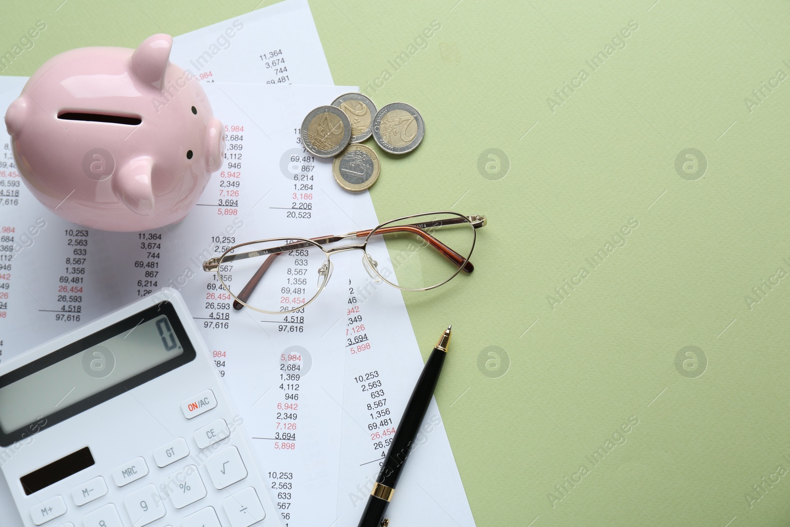 Photo of Flat lay composition with piggy bank and calculator on green background. Space for text