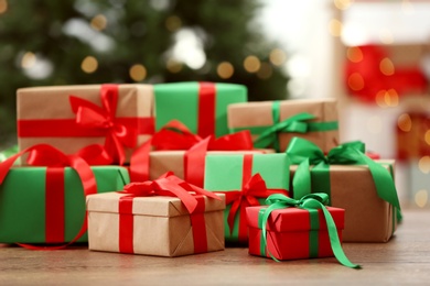 Photo of Many Christmas gifts on table against blurred background