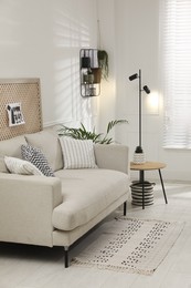 Photo of Comfortable sofa in stylish living room. Interior design