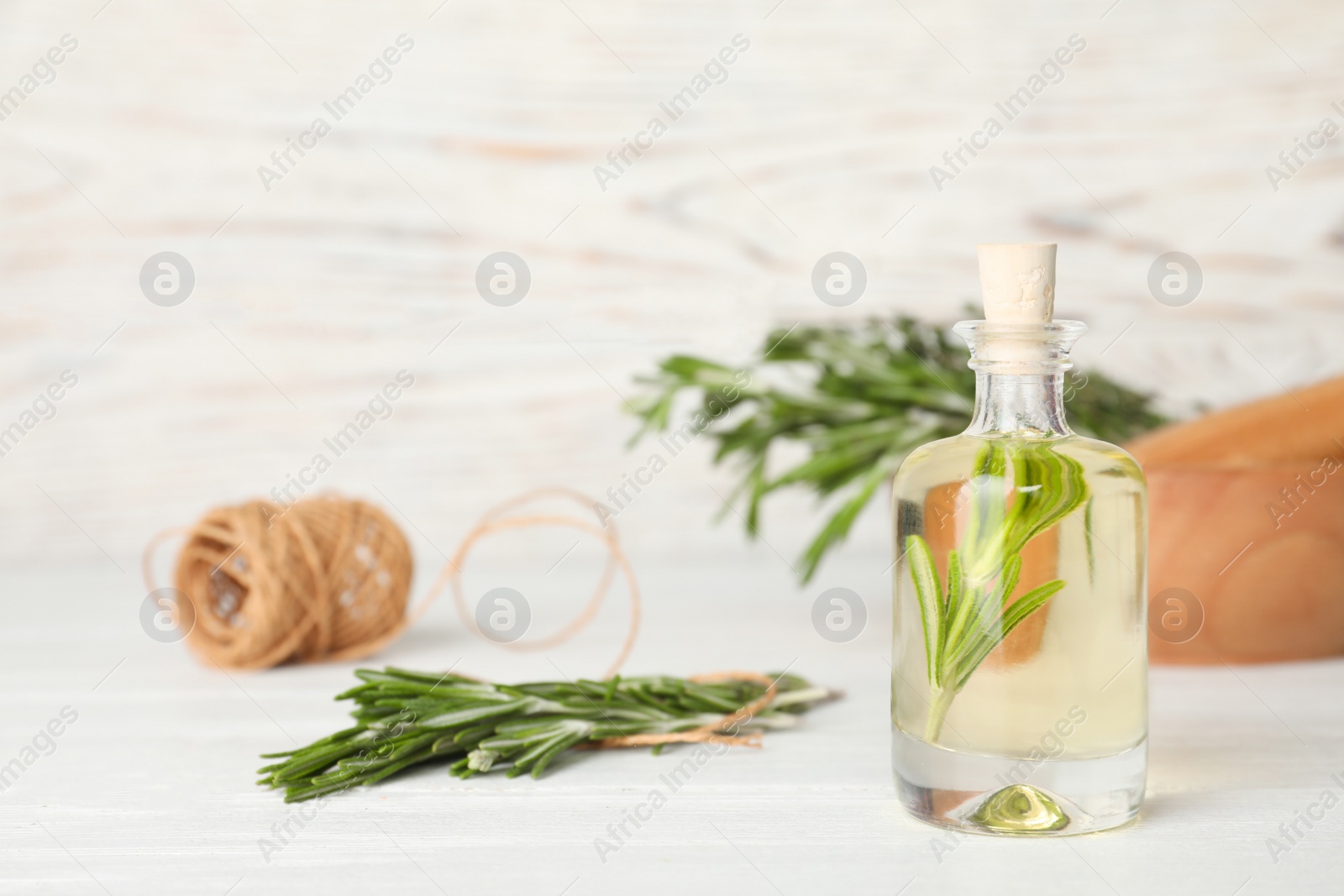 Photo of Composition with essential oil in glass bottle on table. Space for text