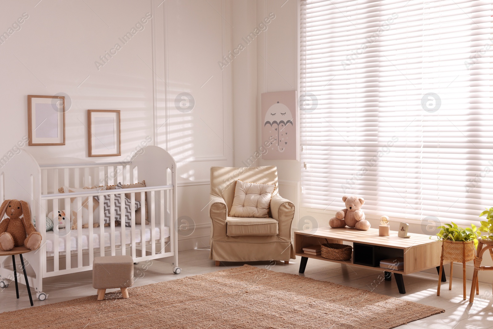 Photo of Beautiful baby room interior with toys and modern crib