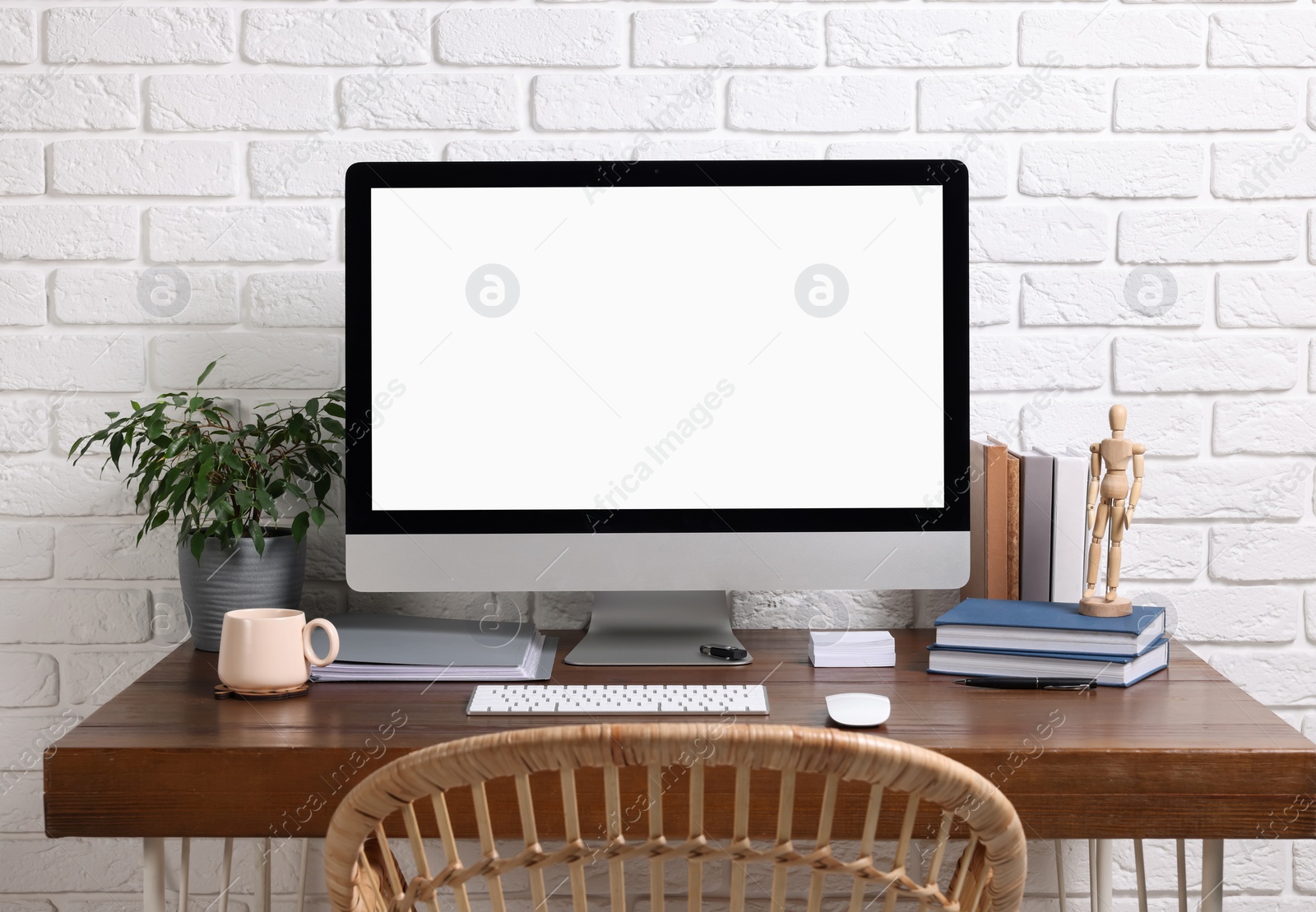 Photo of Cozy workspace with modern computer on wooden desk