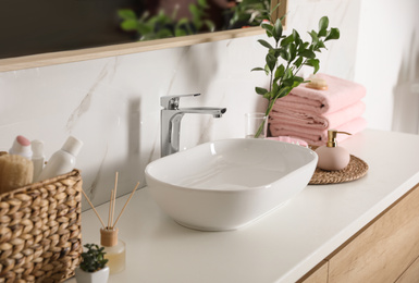 Photo of Modern vessel sink with faucet in stylish bathroom