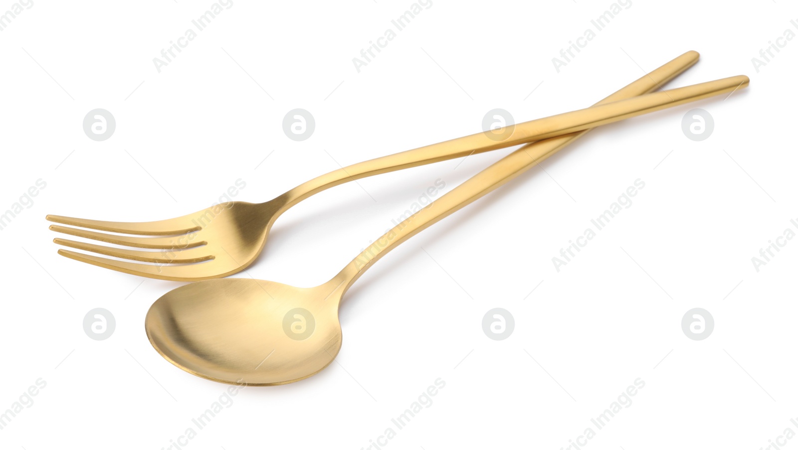 Photo of Shiny golden fork and spoon isolated on white. Luxury cutlery