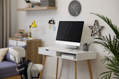 Photo of Modern teenager's room interior with stylish workplace