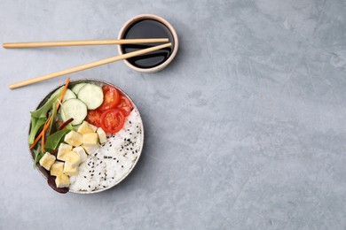 Photo of Delicious poke bowl with vegetables, tofu and mesclun served on light grey table, flat lay. Space for text