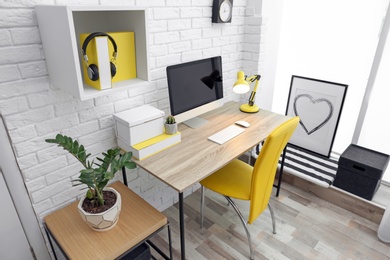 Photo of Comfortable workplace with computer on desk in home office