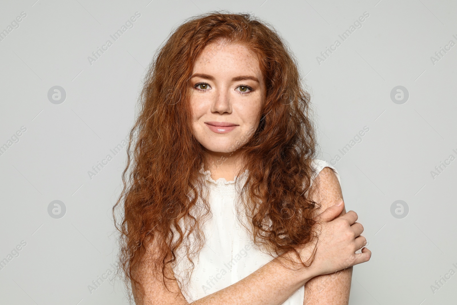 Photo of Portrait of young woman with beautiful face on grey background