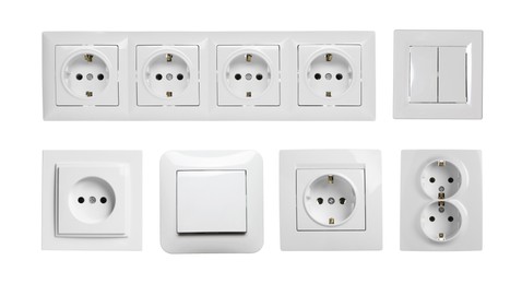 Set with modern plastic power sockets and light switches on white background. Banner design