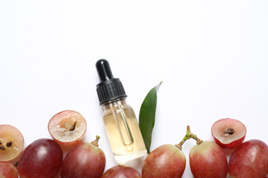 Photo of Composition with natural grape seed oil on white background, top view. Organic cosmetic