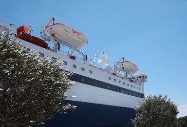 Modern ferry with lifeboats on sunny day, low angle view