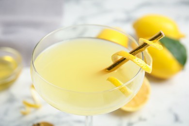 Photo of Delicious bee's knees cocktail on white table, closeup
