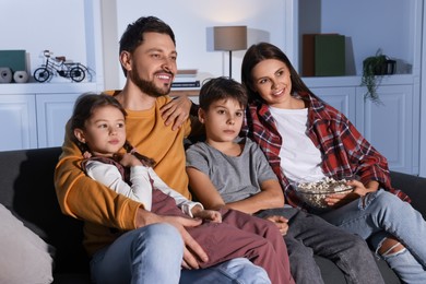 Photo of Family watching TV at home in evening