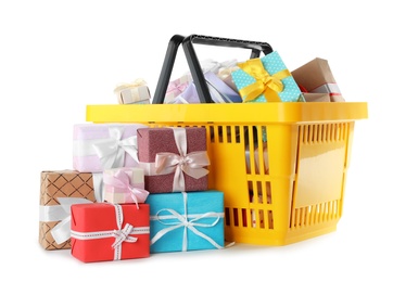 Yellow shopping basket with different gifts on white background