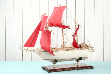Beautiful ship model on light blue wooden table
