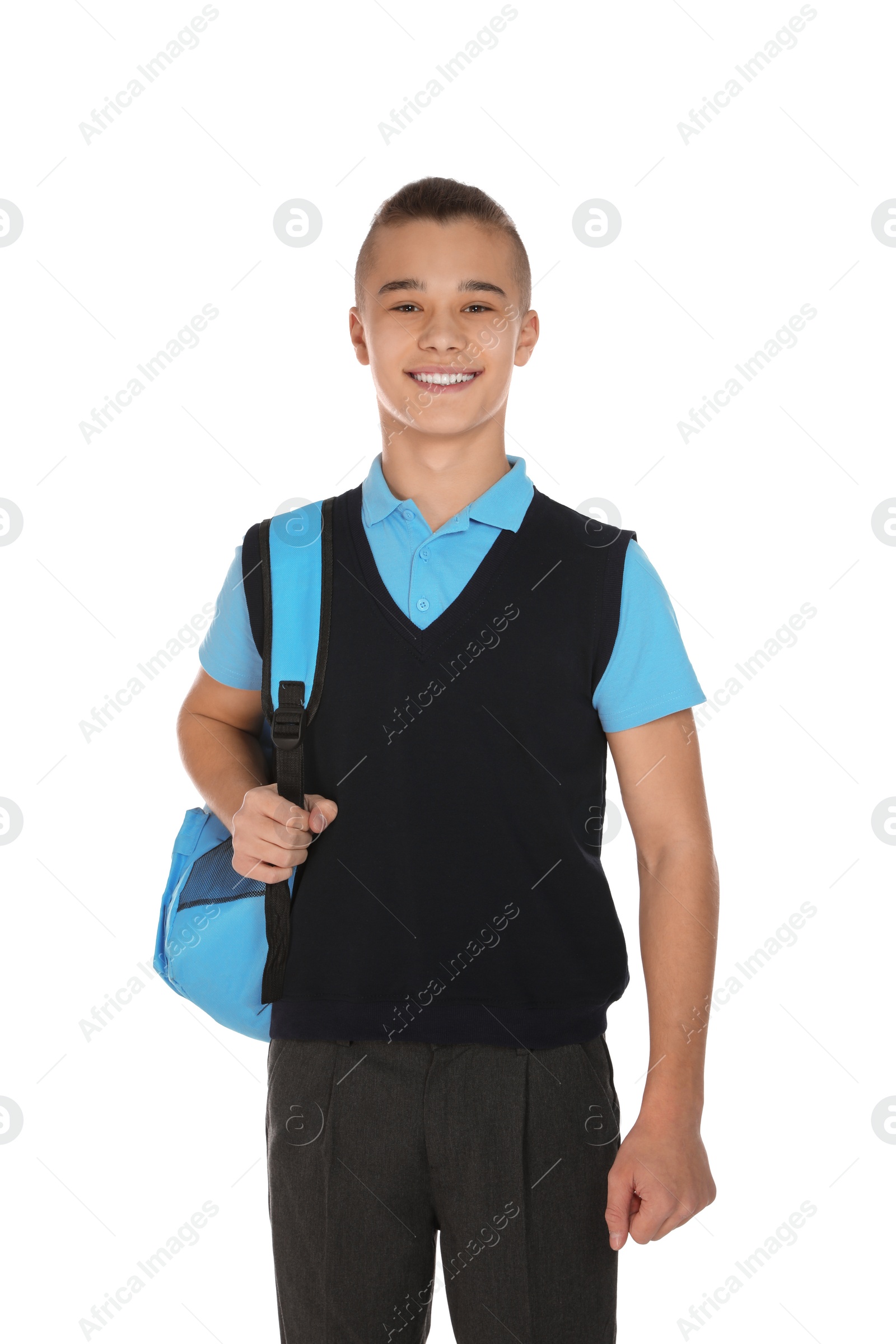 Photo of Portrait of teenage boy in school uniform with backpack on white background