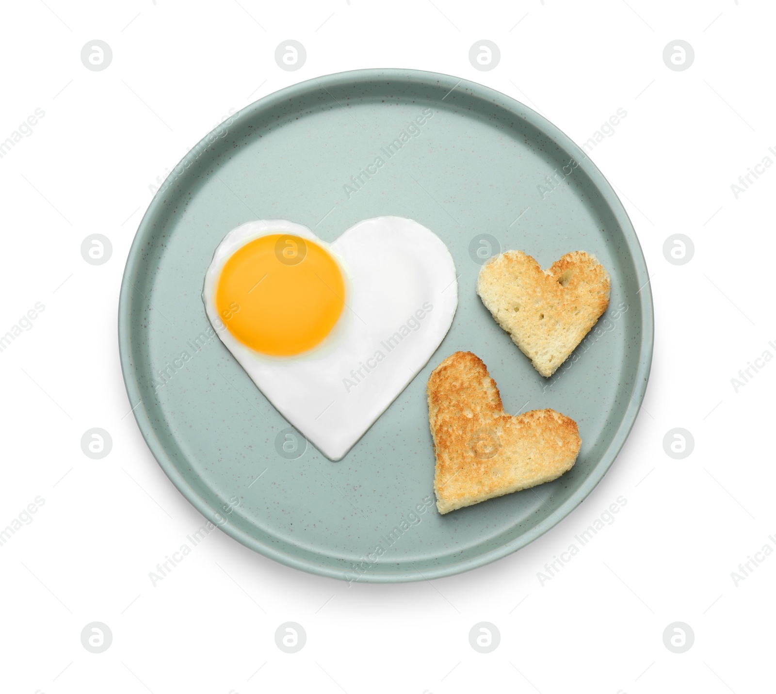 Photo of Romantic breakfast with heart shaped fried egg and toasts on white background, top view