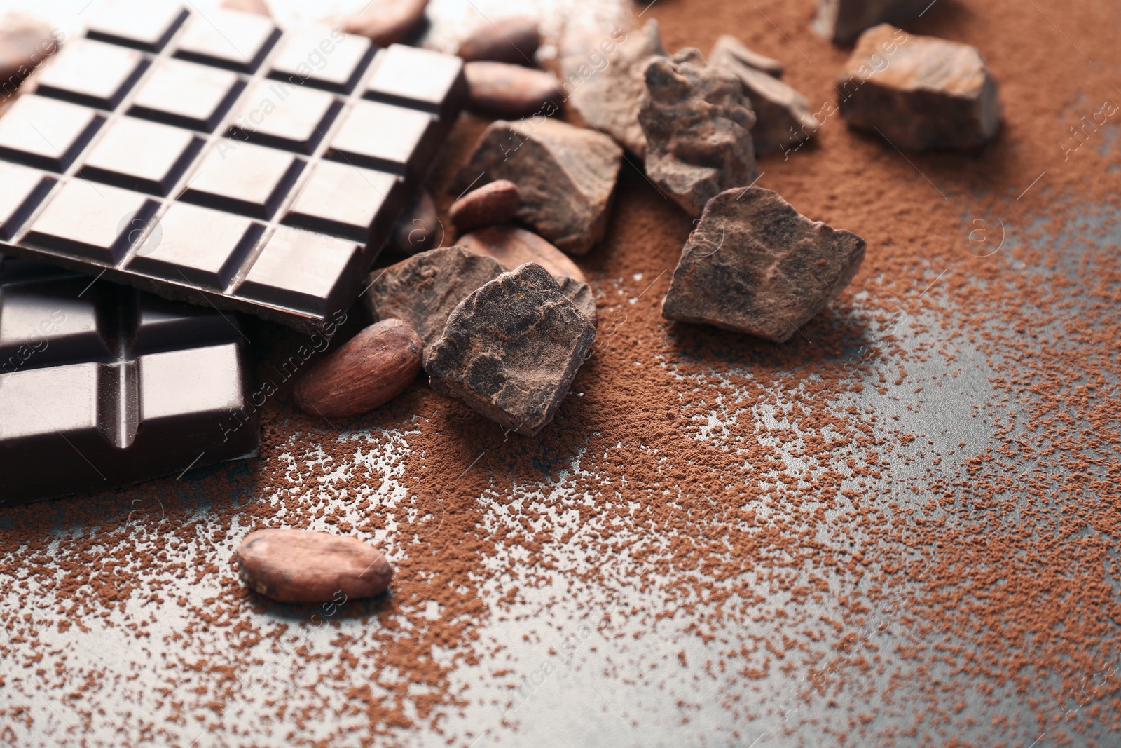 Photo of Composition with cocoa powder and chocolate on grey background
