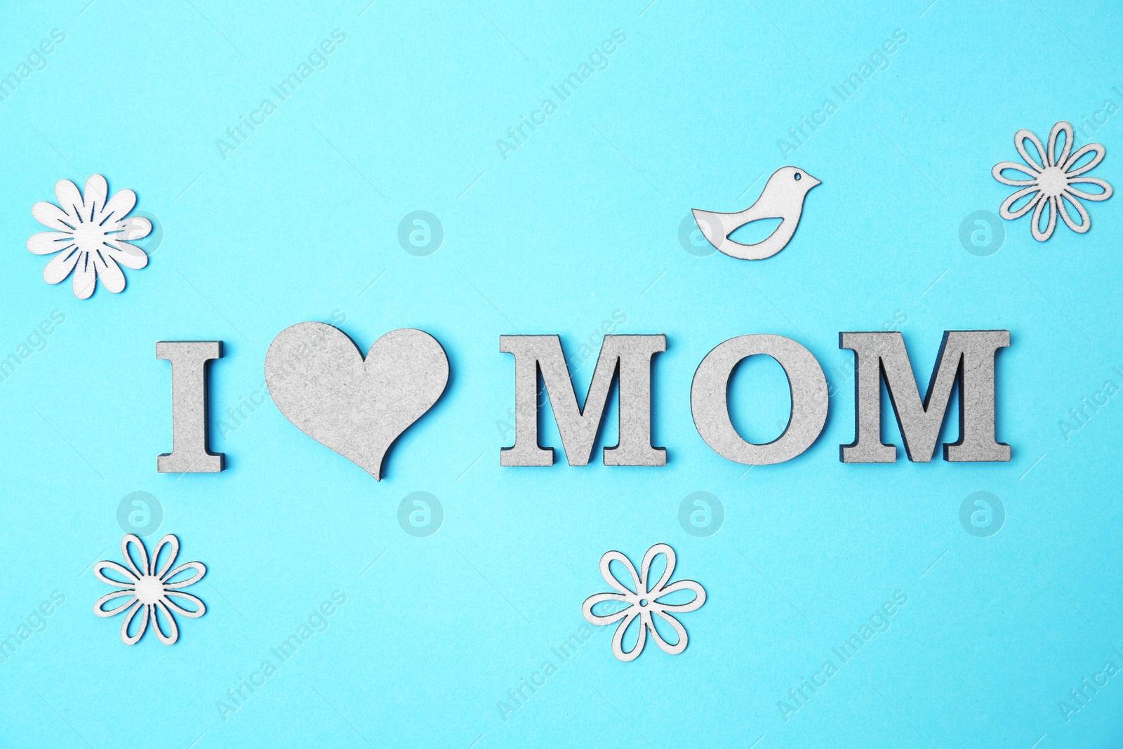 Photo of Phrase "I LOVE MOM" made of letters on color background. Happy Mother's Day