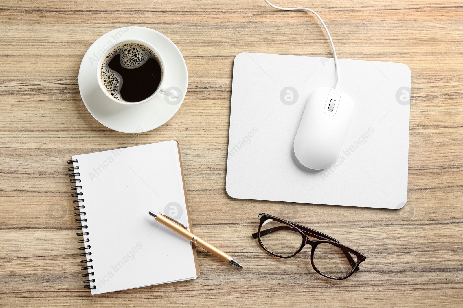 Photo of Flat lay composition with mouse and cup of coffee on wooden table