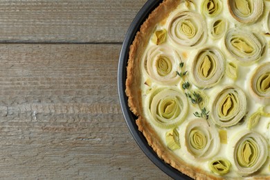 Tasty leek pie on wooden table, top view. Space for text