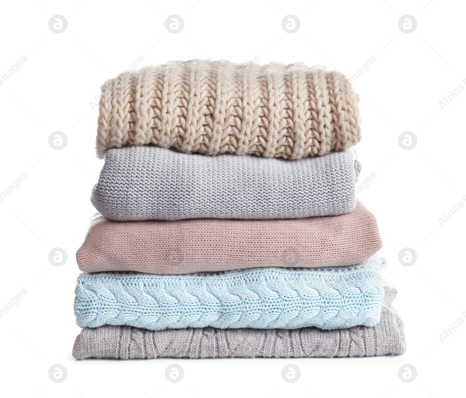 Photo of Stack of warm knitted clothes on white background