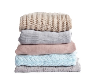 Photo of Stack of warm knitted clothes on white background